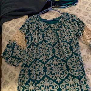 Dress: green with white swirls.